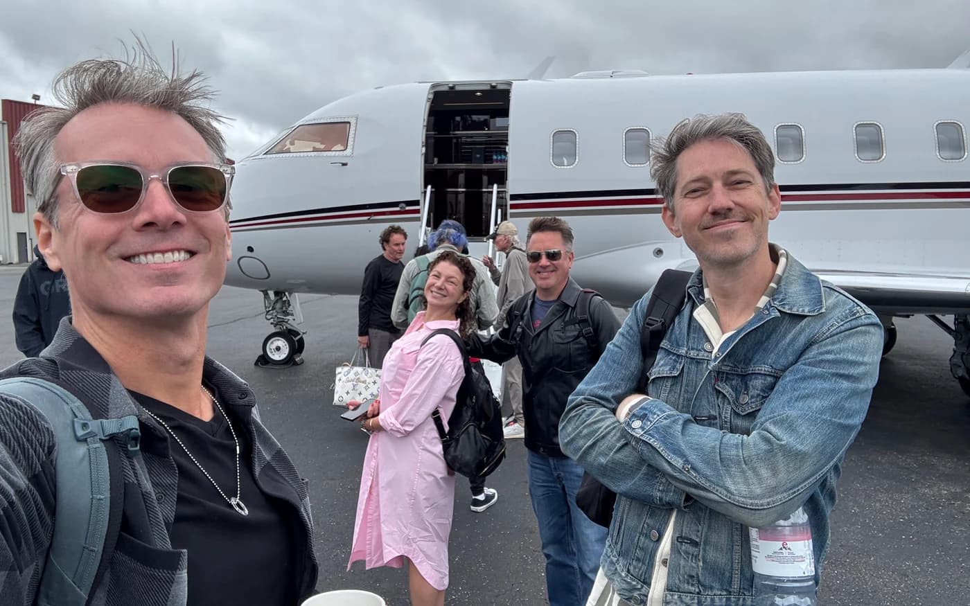 Brian Eichenberger and Chris Cron beside a plane while on tour with The Beach Boys