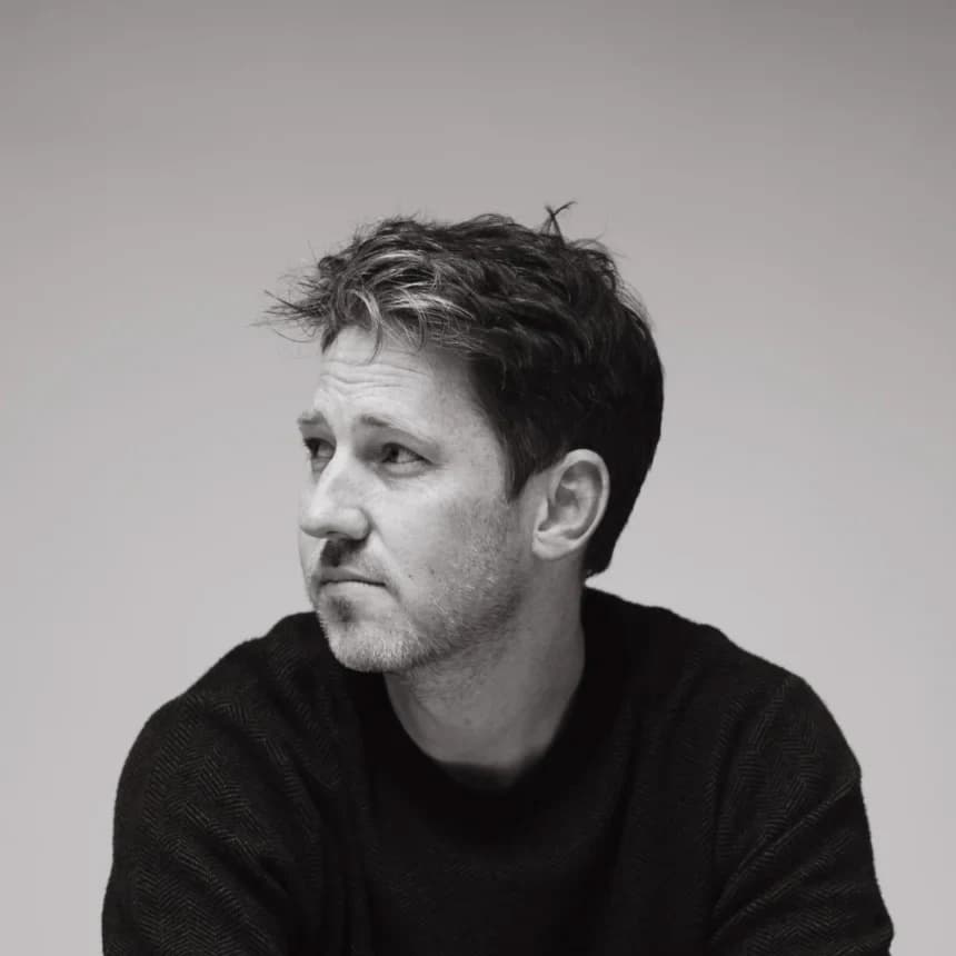 Chris Cron looking to the side in a black-and-white portrait